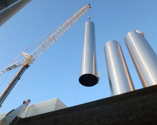 Construction crane placing stainless steel vessels at Hood Dairy Facility.